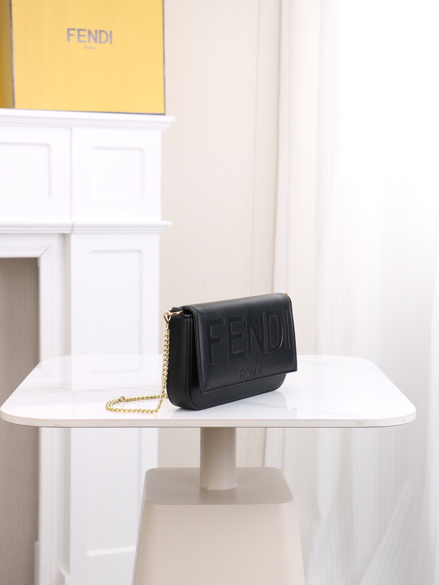 C2864 Fendi mini handbag with geometric pattern flap, equipped with zipper closure. Removable chain shoulder strap. Inner lining features flat pockets. The bag’s exterior is made of iconic brown leather with black raised FF print patterns. It includes two — image 2