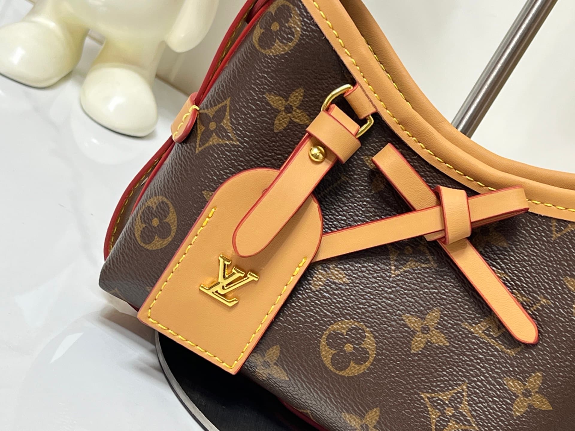 C5077 💰M2A711 Patterned design. This Nano CarryAll handbag brings a fresh touch of classic style to everyday use. The monogram pattern is presented on canvas, with contrasting leather trim at the straps; the details are elegant, and the name tag features  — image 6