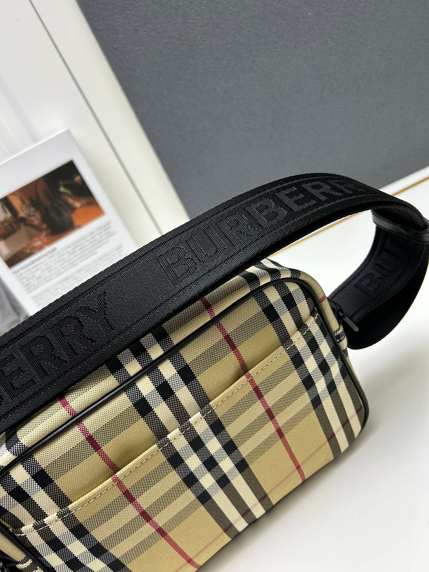 C34 [Brand B] 200: A vibrant decorative bag with a plaid pattern in the “Bur” style. It features a belt with a brand logo embroidery. Adjustable diagonal shoulder strap; a zipper pocket on the outside; a external pocket on 1 that opens using magnetic fast — image 6