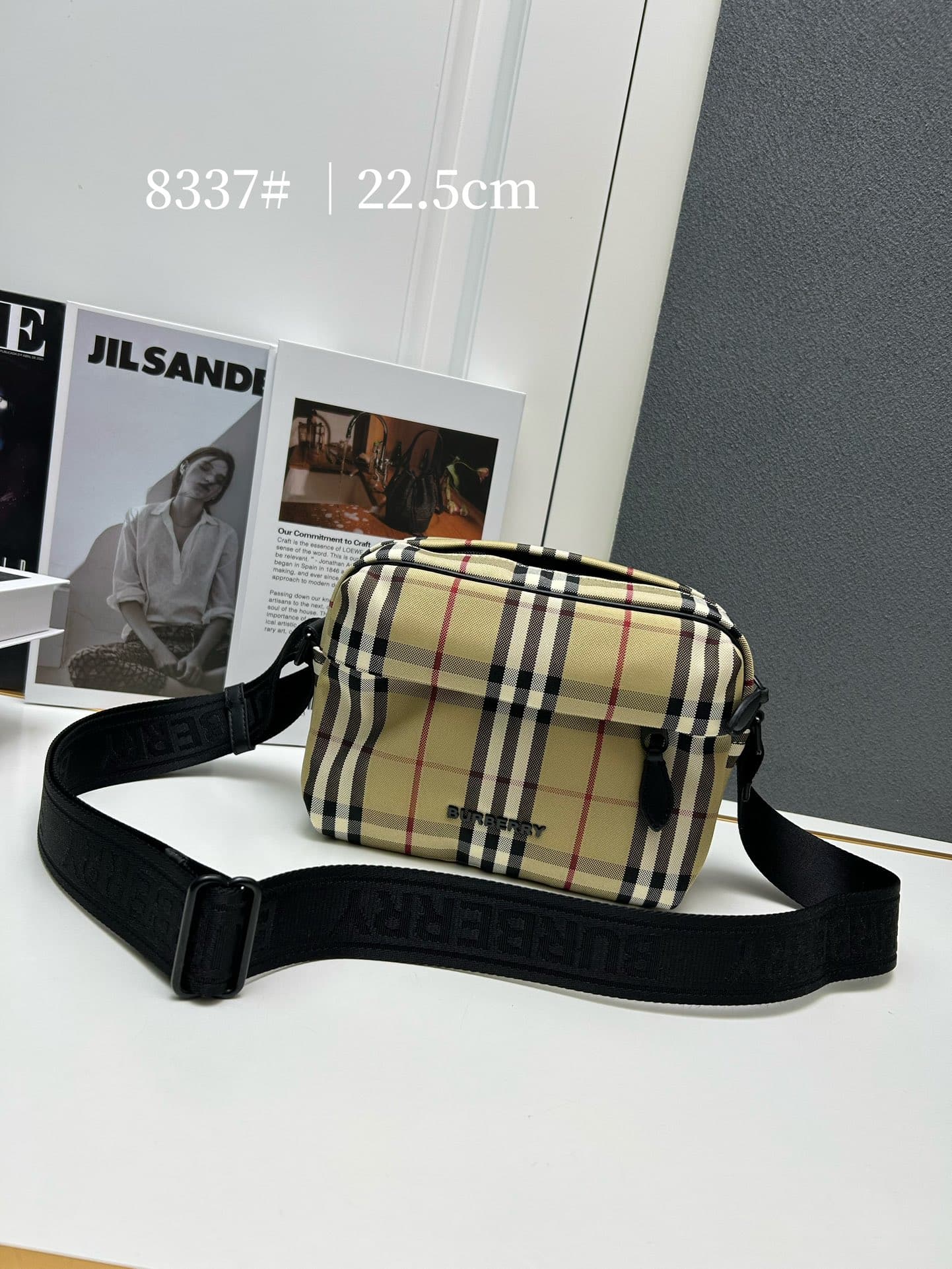 C34 [Brand B] 200: A vibrant decorative bag with a plaid pattern in the “Bur” style. It features a belt with a brand logo embroidery. Adjustable diagonal shoulder strap; a zipper pocket on the outside; a external pocket on 1 that opens using magnetic fast — image 1