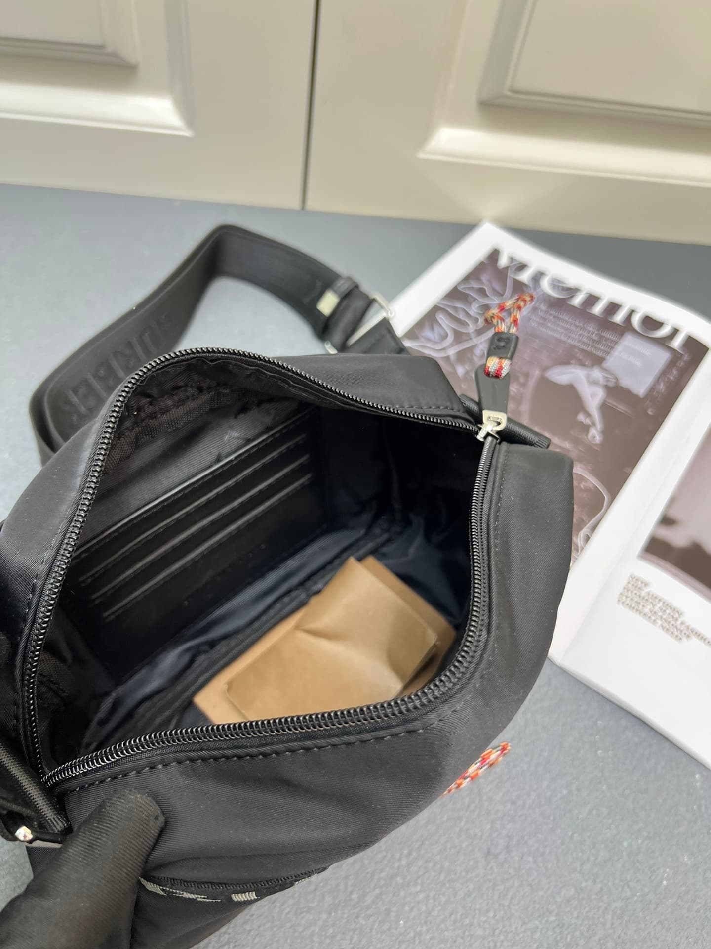 C37 [Brand B] 200: A vibrant decorative bag with a checked pattern in the “Paddy” style, featuring a brand logo embroidered on the strap. Adjustable diagonal shoulder strap; a zipper pocket; a magnetic closure external pocket. The zipper closure is also a — image 8