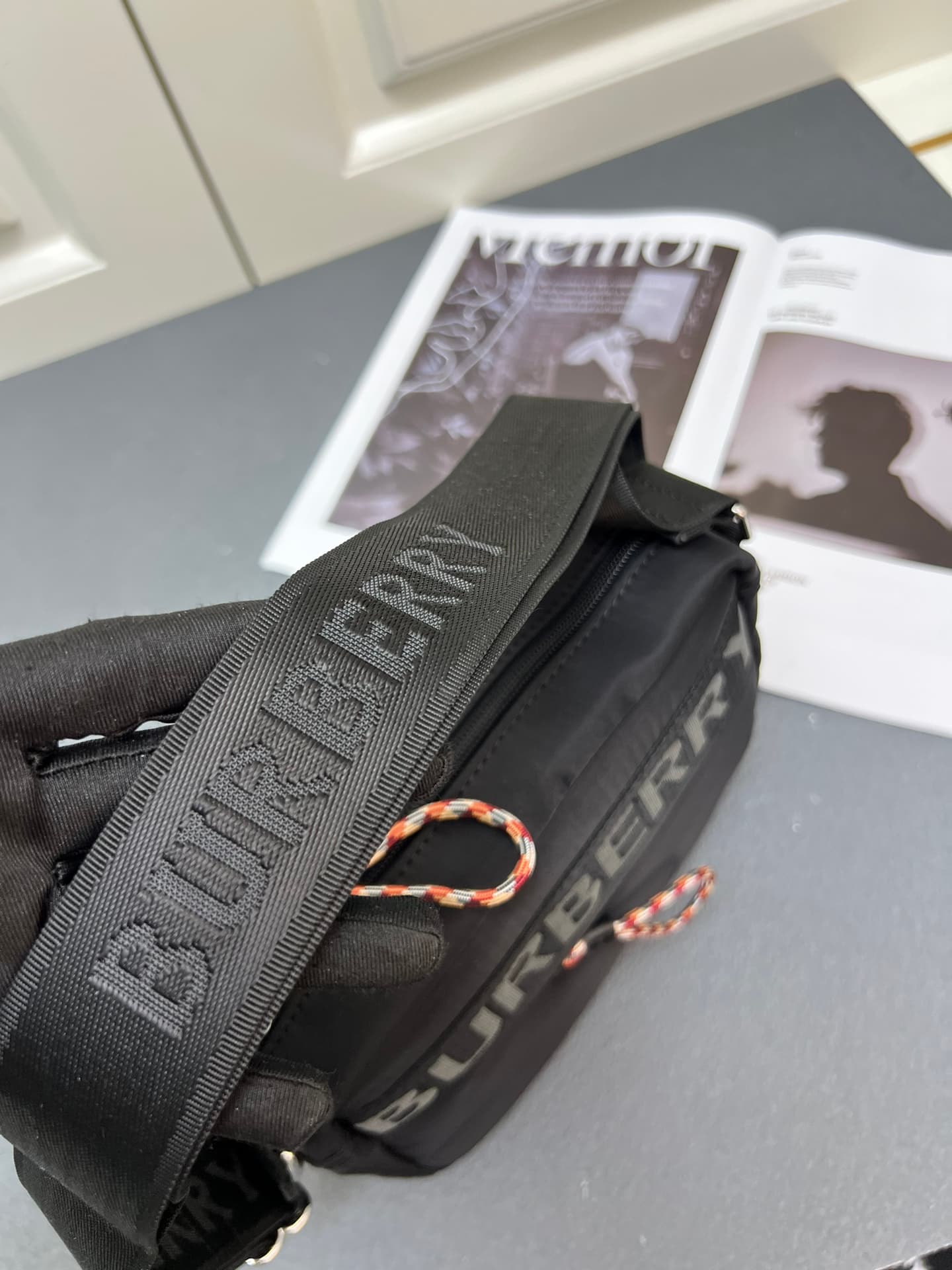 C37 [Brand B] 200: A vibrant decorative bag with a checked pattern in the “Paddy” style, featuring a brand logo embroidered on the strap. Adjustable diagonal shoulder strap; a zipper pocket; a magnetic closure external pocket. The zipper closure is also a — image 6