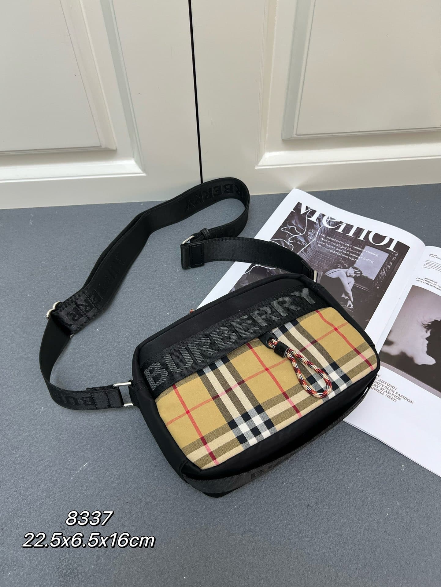 C36 [Brand B] 200: A vibrant decorative bag with a plaid pattern in the “Bur” style. It features a strap with a brand logo embroidered on it. There is an adjustable diagonal shoulder strap, as well as a zipper pocket. The 1 external pocket is opened using — image 1
