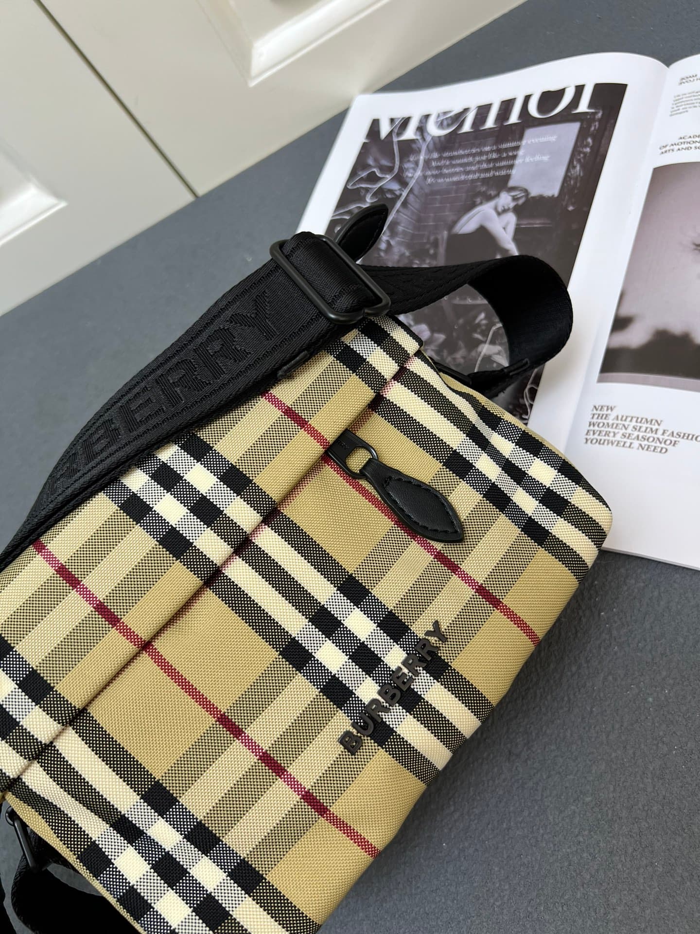 C35 [Brand B] 200: A vibrant decorative bag with a plaid pattern in the “Bur” style. It features a zipper strap adorned with the brand logo. There is an adjustable diagonal strap, a zipper pocket, and an external pocket that opens via magnetic closures or — image 7