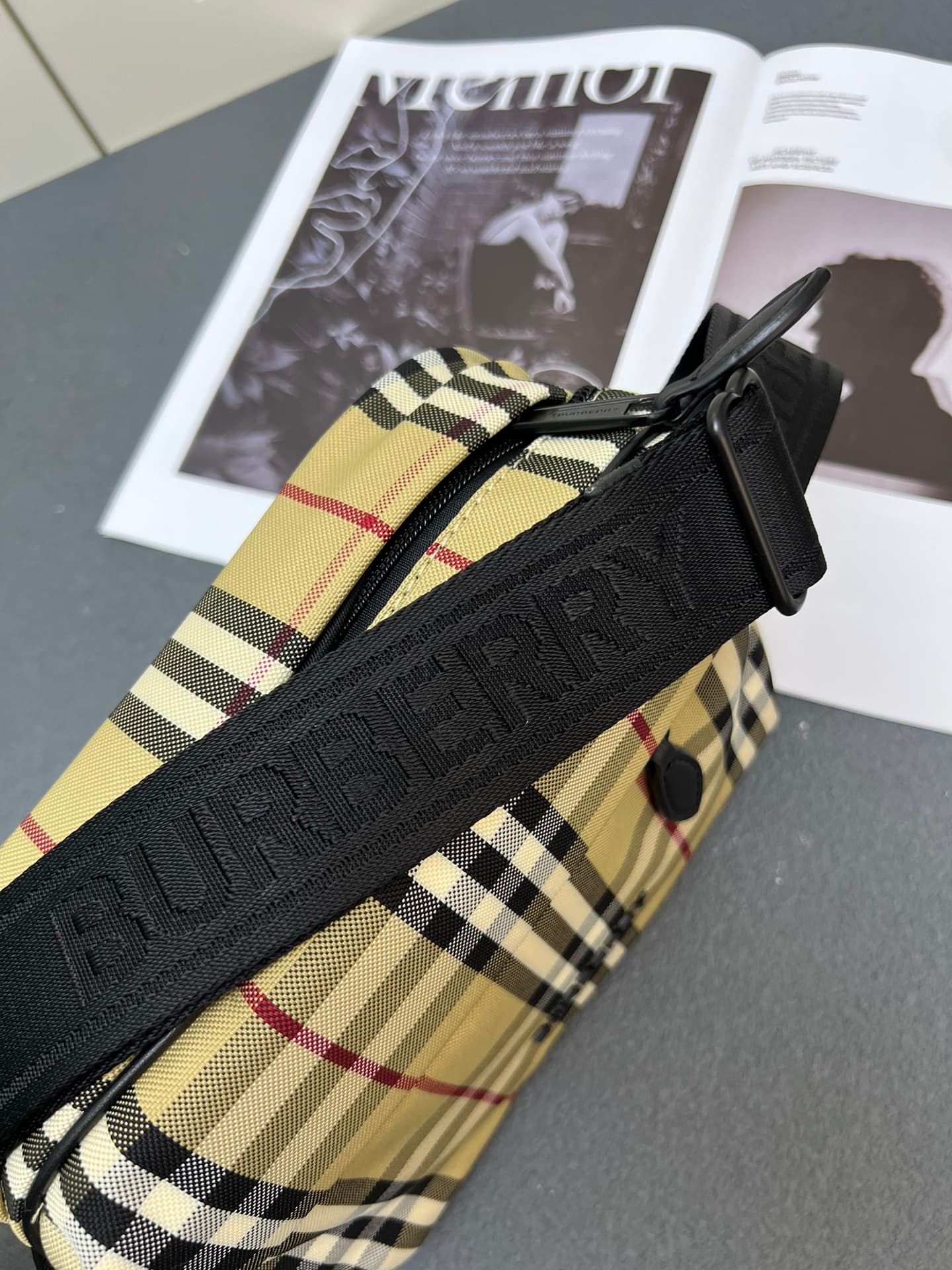 C35 [Brand B] 200: A vibrant decorative bag with a plaid pattern in the “Bur” style. It features a zipper strap adorned with the brand logo. There is an adjustable diagonal strap, a zipper pocket, and an external pocket that opens via magnetic closures or — image 6