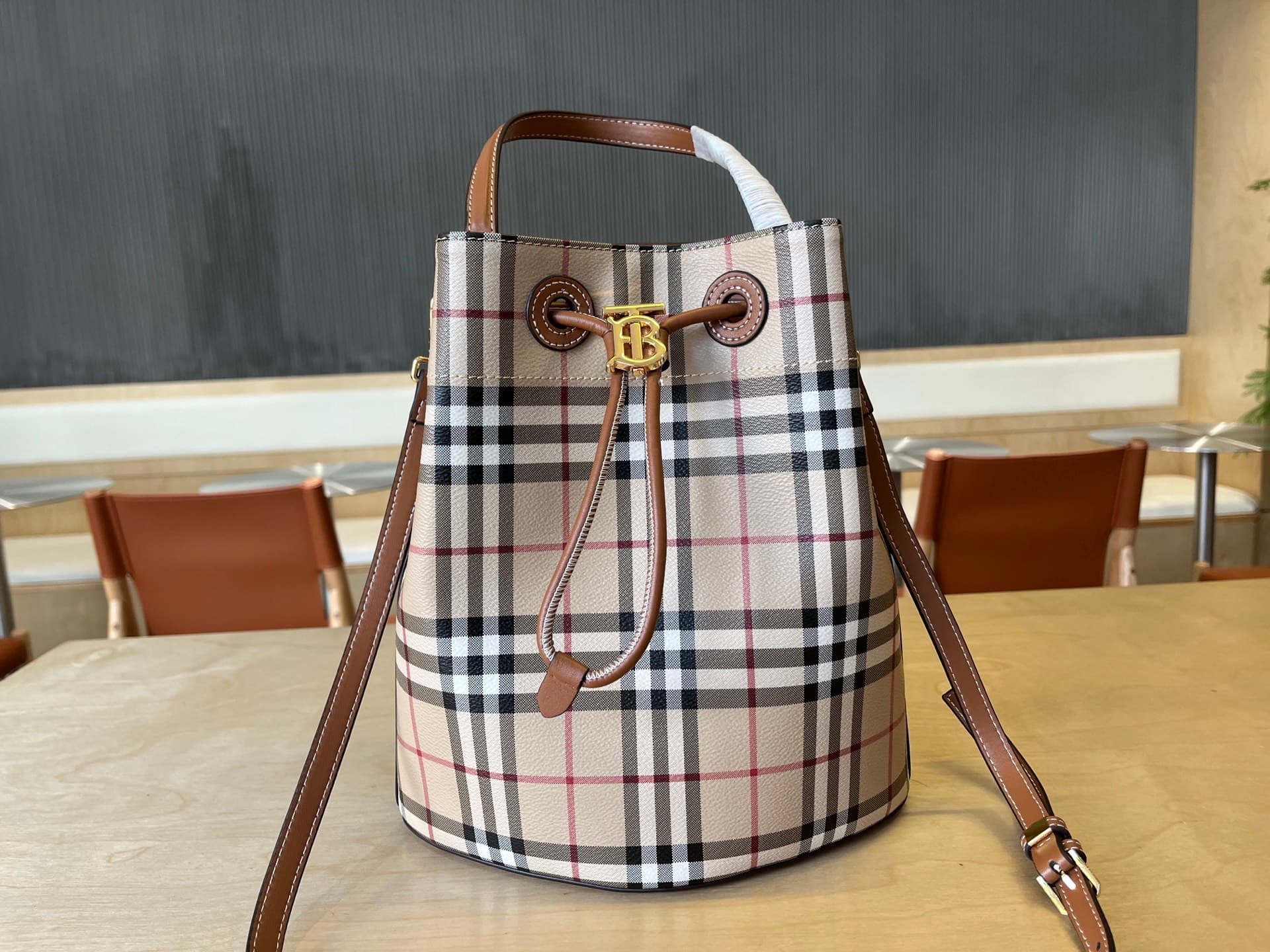 C14 B brand's latest bucket bag, crafted from large-sized patterned and ribbed leather material, adorned with the TB exclusive logo. This bag is a new member of the TB bag collection series, featuring a detachable and adjustable sling shoulder strap, and  — image 2