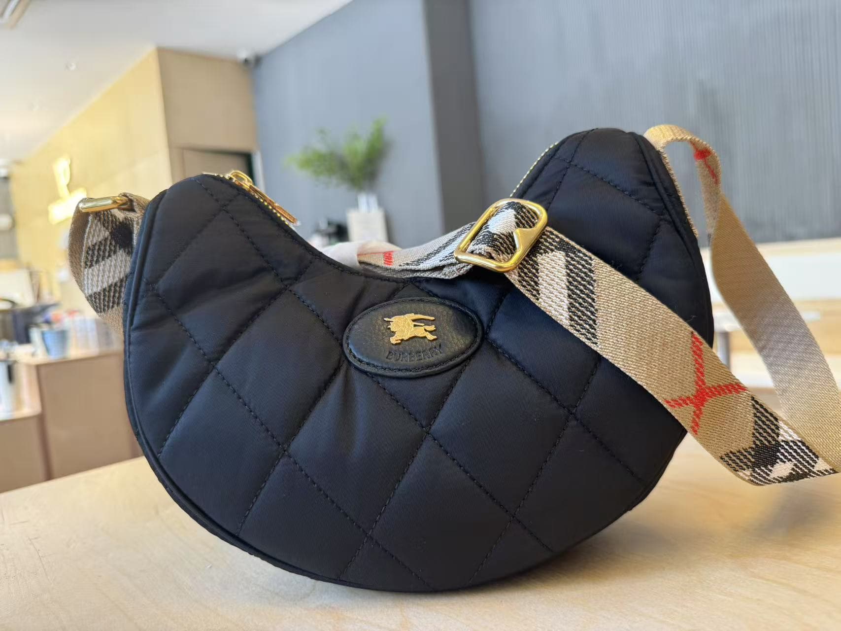 C44 [B’s top-tier original products] Slanted backpack, inspired by the elegance of English countryside. Made from quilted nylon blend fabric, adorned with fine-broken Bur pattern in the new season’s colors. Features leather trim and a knight’s seal in the — image 2