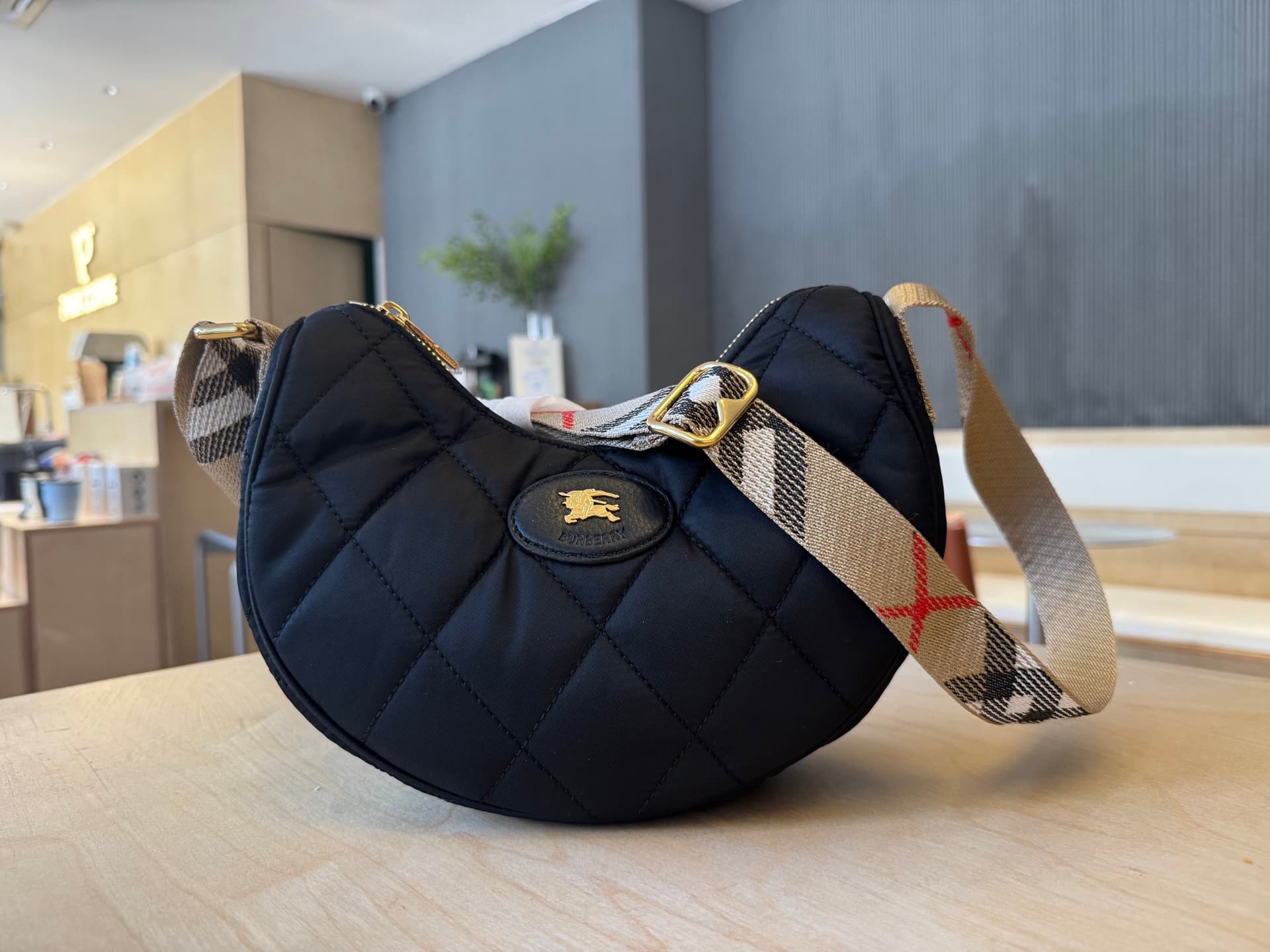 C44 [B’s top-tier original products] Slanted backpack, inspired by the elegance of English countryside. Made from quilted nylon blend fabric, adorned with fine-broken Bur pattern in the new season’s colors. Features leather trim and a knight’s seal in the — image 1