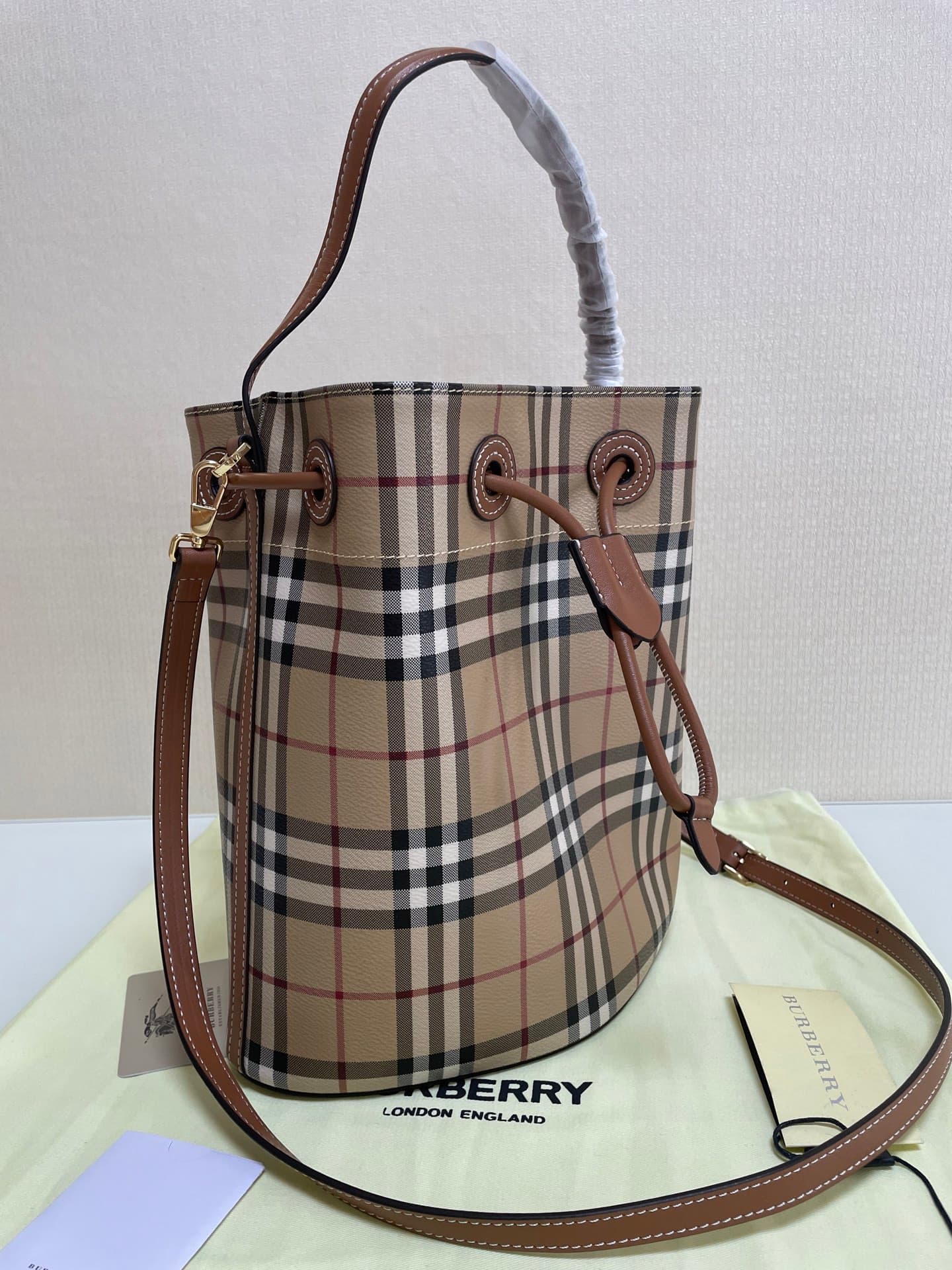 C12 B brand's latest bucket bag, crafted from large vintage/retro checked and glossy thread leather, adorned with the TB exclusive logo. This bag is a new member of the TB bag collection, featuring a detachable adjustable crossbody strap and an inner pock — image 2