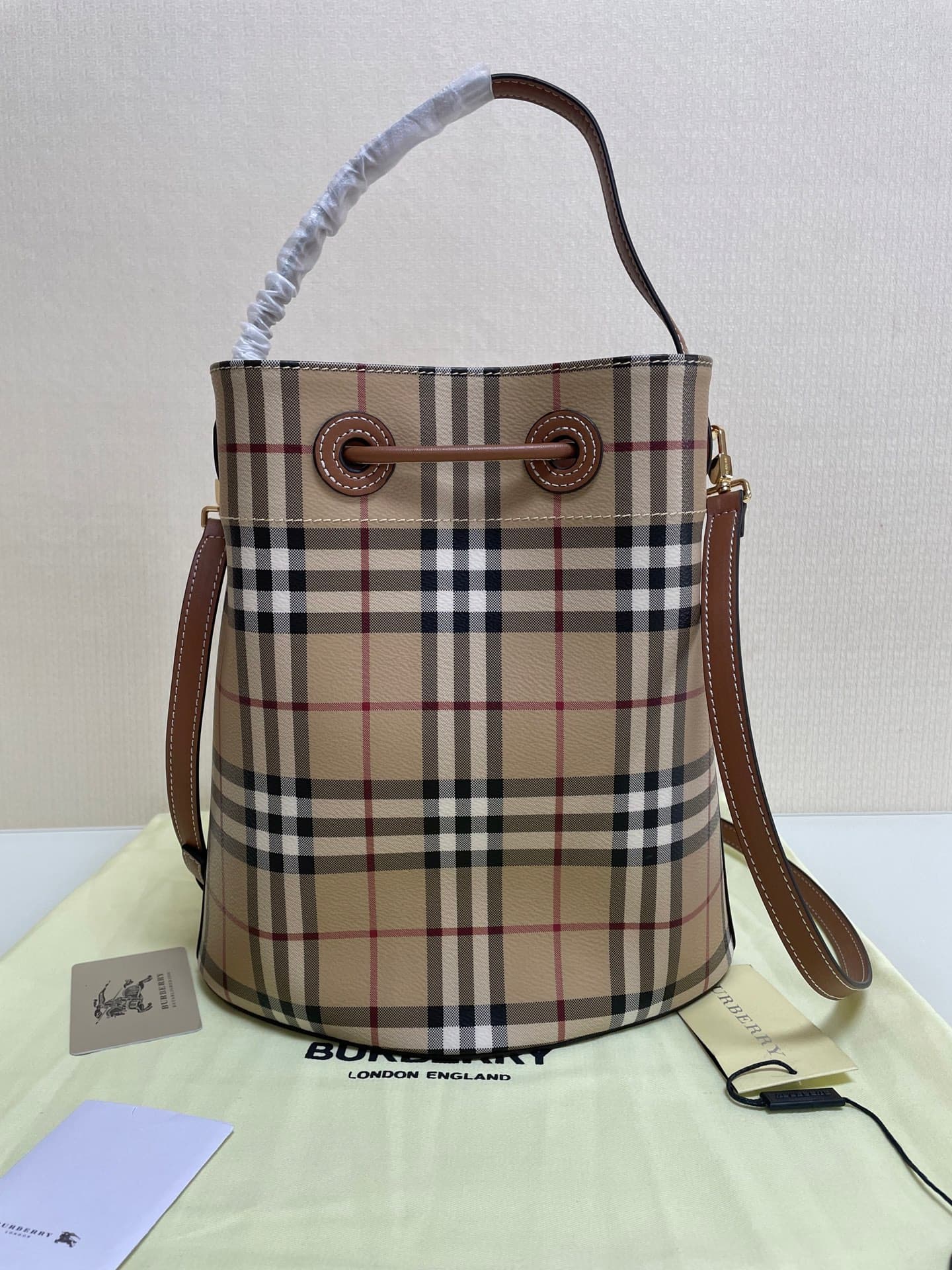 C12 B brand's latest bucket bag, crafted from large vintage/retro checked and glossy thread leather, adorned with the TB exclusive logo. This bag is a new member of the TB bag collection, featuring a detachable adjustable crossbody strap and an inner pock — image 3