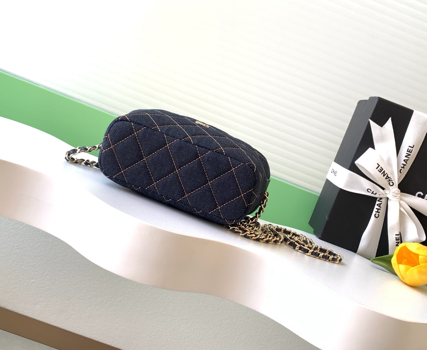 C725 26P Denim lunchbox bag: dark denim fabric with classic diamond pattern design; metal chains and leather straps. It can be carried in hand, over shoulder, or crossbody style. The bag is small and cute in size; it has enough space for a phone, keys, an — image 4