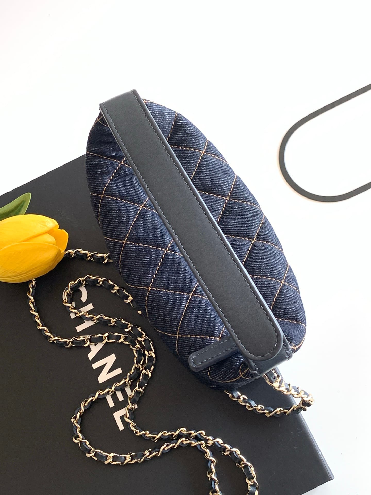 C725 26P Denim lunchbox bag: dark denim fabric with classic diamond pattern design; metal chains and leather straps. It can be carried in hand, over shoulder, or crossbody style. The bag is small and cute in size; it has enough space for a phone, keys, an — image 6
