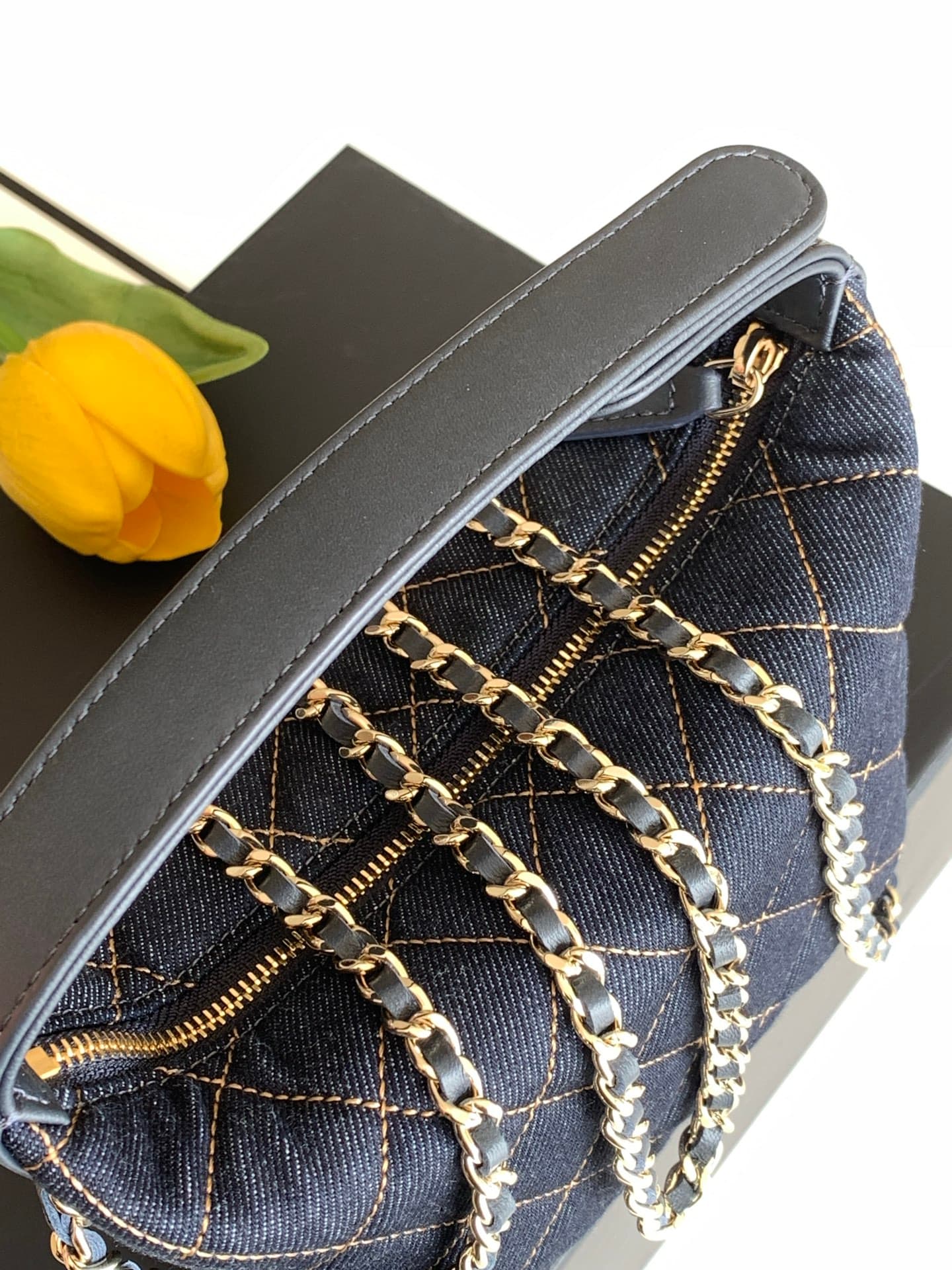 C725 26P Denim lunchbox bag: dark denim fabric with classic diamond pattern design; metal chains and leather straps. It can be carried in hand, over shoulder, or crossbody style. The bag is small and cute in size; it has enough space for a phone, keys, an — image 7