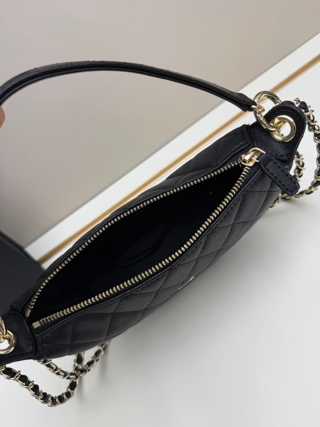 C682 Chanel 26 is a new underarm bag, with a crescent-shaped design. It’s very lightweight and can be carried across the shoulder. Leather made from grainy cowhide is considered one of the most durable materials used by Chanel; it doesn’t wear out easily. — image 7