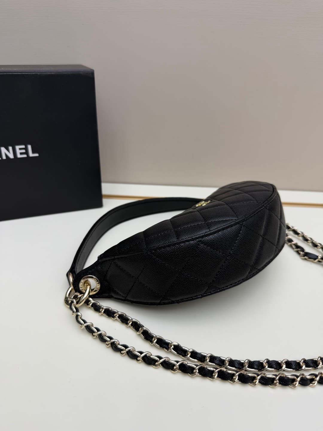 C682 Chanel 26 is a new underarm bag, with a crescent-shaped design. It’s very lightweight and can be carried across the shoulder. Leather made from grainy cowhide is considered one of the most durable materials used by Chanel; it doesn’t wear out easily. — image 2