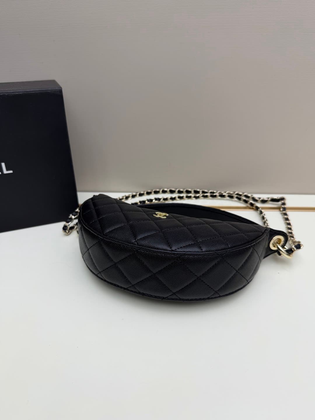 C682 Chanel 26 is a new underarm bag, with a crescent-shaped design. It’s very lightweight and can be carried across the shoulder. Leather made from grainy cowhide is considered one of the most durable materials used by Chanel; it doesn’t wear out easily. — image 5