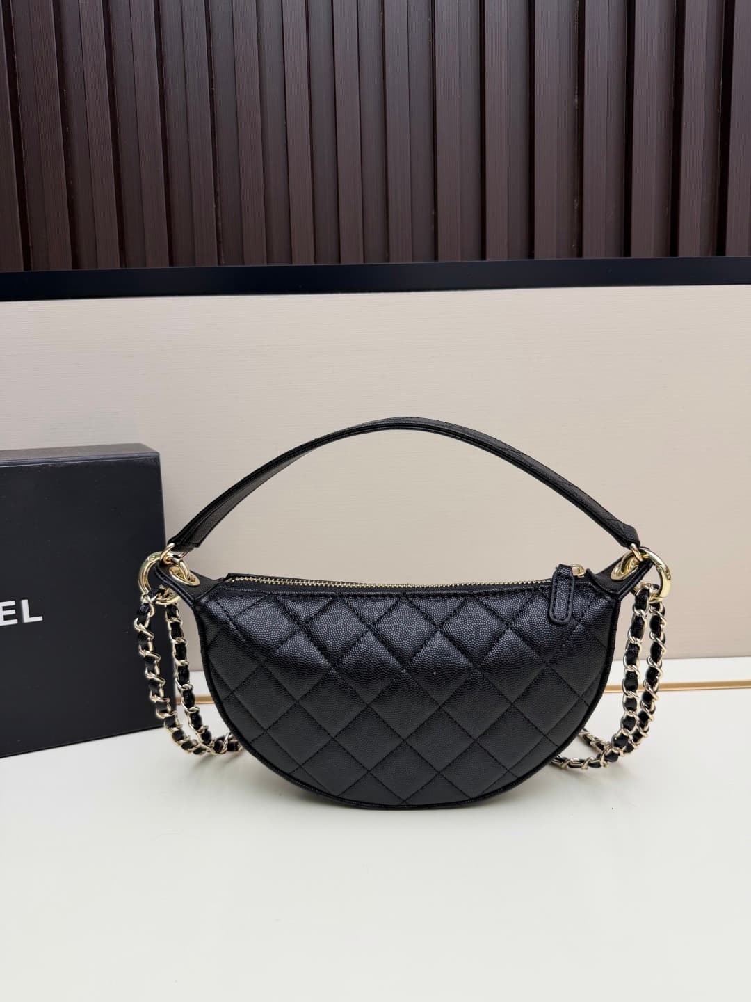 C682 Chanel 26 is a new underarm bag, with a crescent-shaped design. It’s very lightweight and can be carried across the shoulder. Leather made from grainy cowhide is considered one of the most durable materials used by Chanel; it doesn’t wear out easily. — image 3