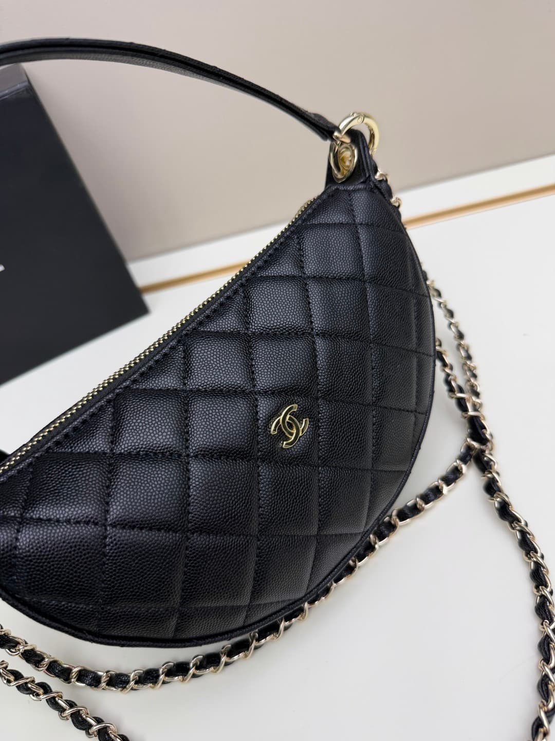 C682 Chanel 26 is a new underarm bag, with a crescent-shaped design. It’s very lightweight and can be carried across the shoulder. Leather made from grainy cowhide is considered one of the most durable materials used by Chanel; it doesn’t wear out easily. — image 4