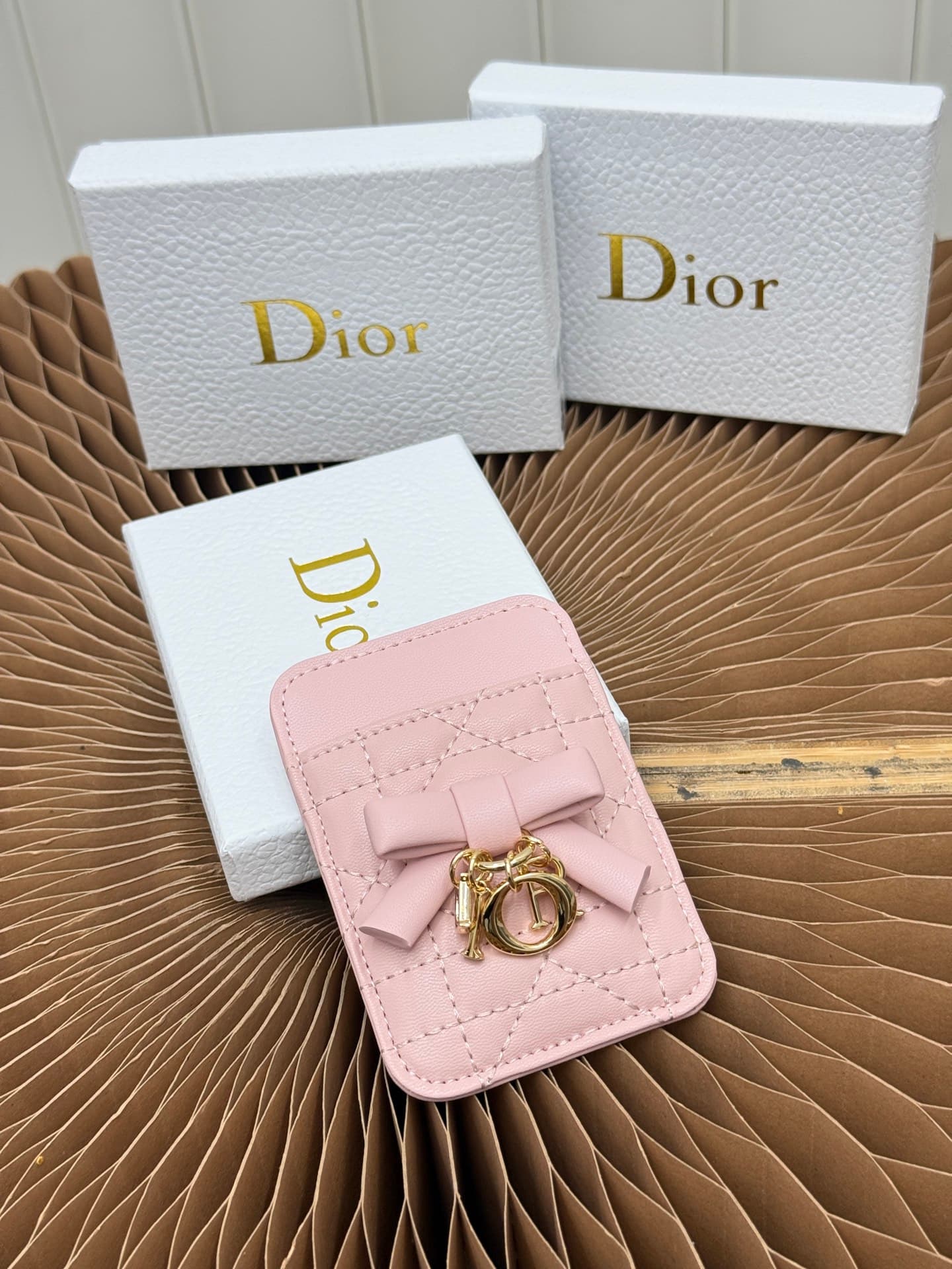 C389 This Lady Dior magnet card case is a delicate accessory that showcases the brand’s exquisite craftsmanship. The Cannage pattern in the lace style, along with the leather details, and the intricate bow ties represent new elements of Dior’s logo, highl — image 1