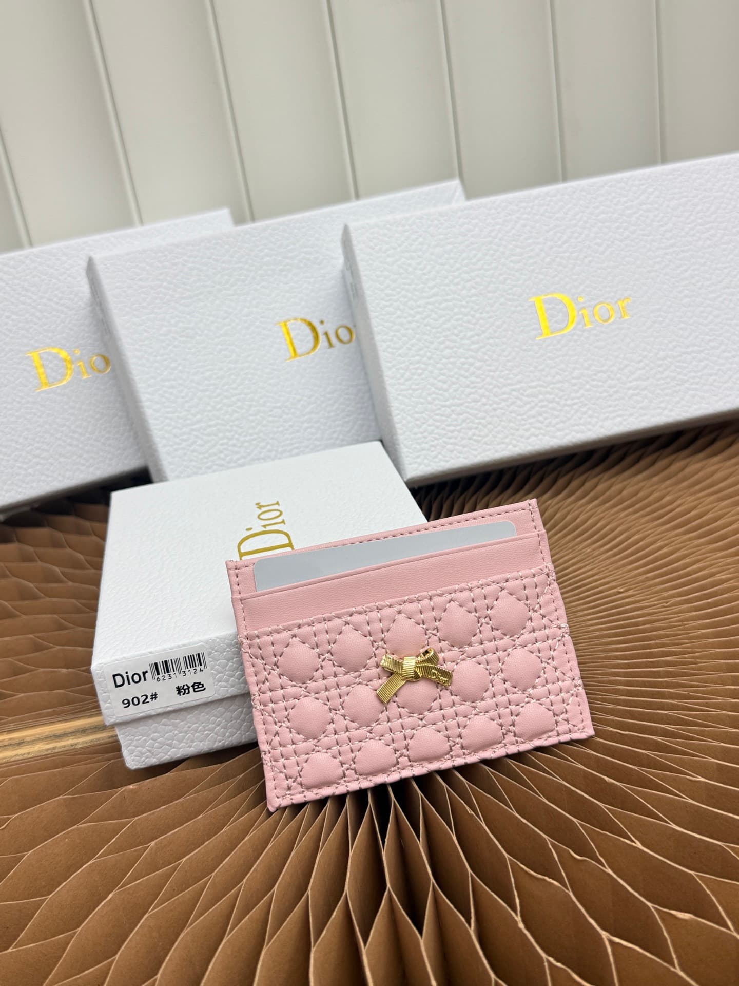 C395 This Baby Bow Freesia card case is designed in a elegant and practical manner. The black mini-check pattern with leather texture, along with delicate bow ties, offers a clever new interpretation of the classic brand’s theme. This exquisite accessory — image 1