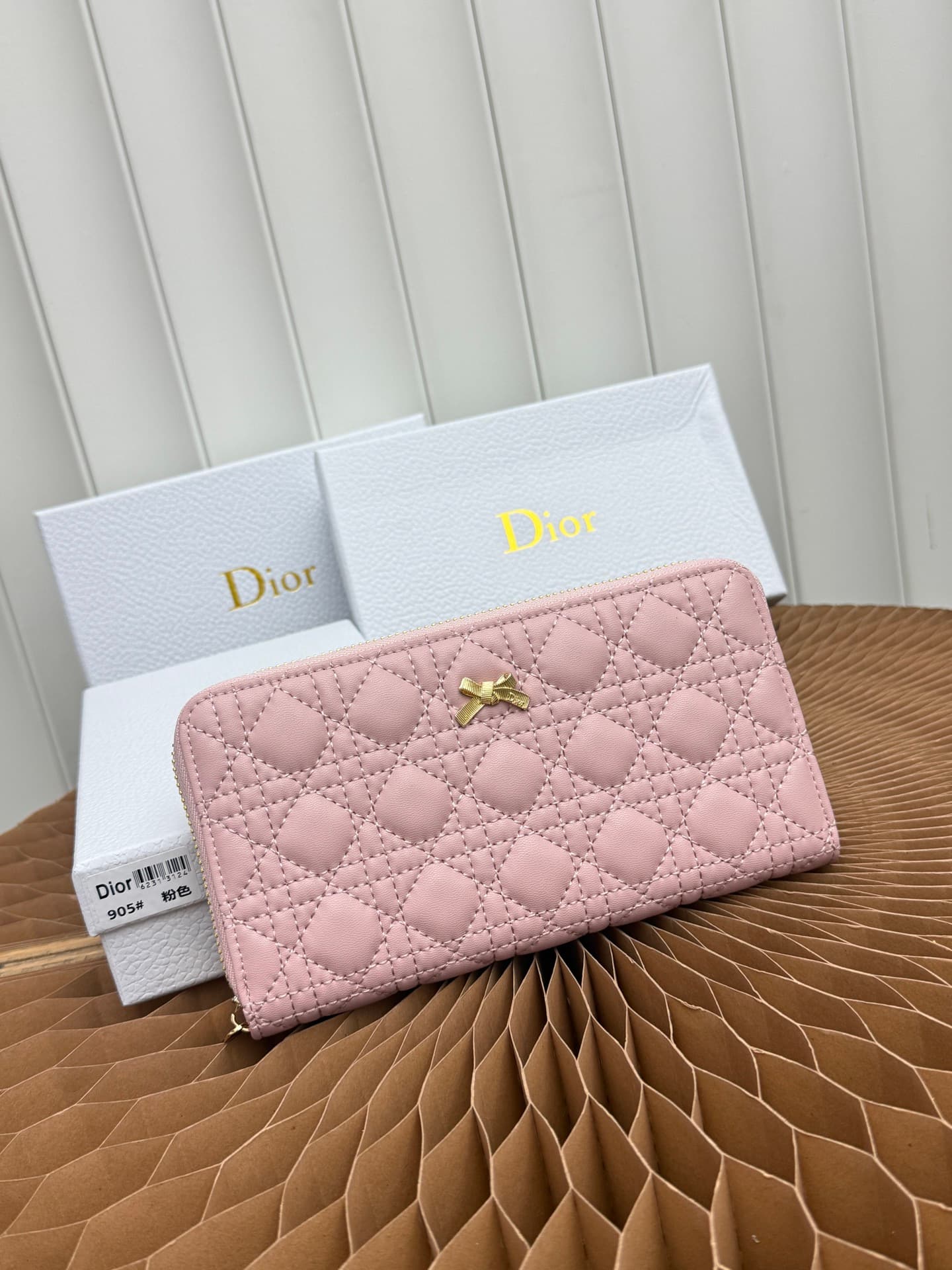 C404 This thin silver wallet from Baby Bow Voyageur is an essential accessory, exuding a simple and elegant style. The black mini rattan-checked pattern with lamb leather, combined with delicate bow ties, offers a clever new interpretation of the classic — image 1