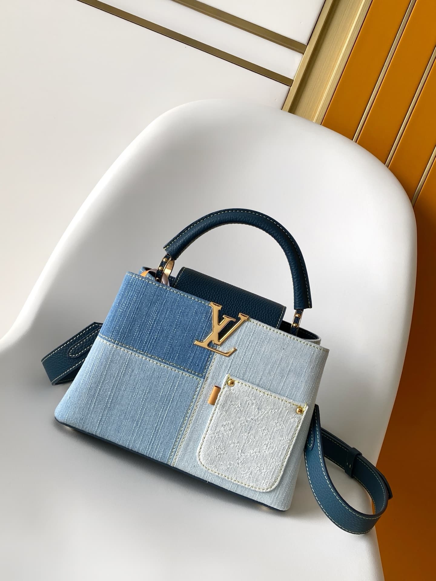 C5264 💰M27302 – Premium original style. The Capucines BB handbag features a denim material, reflecting contemporary fashion trends; its unique color-blocked design is truly distinctive. The bag comes with Taurillon leather handles, a flap closure, and a d — image 1