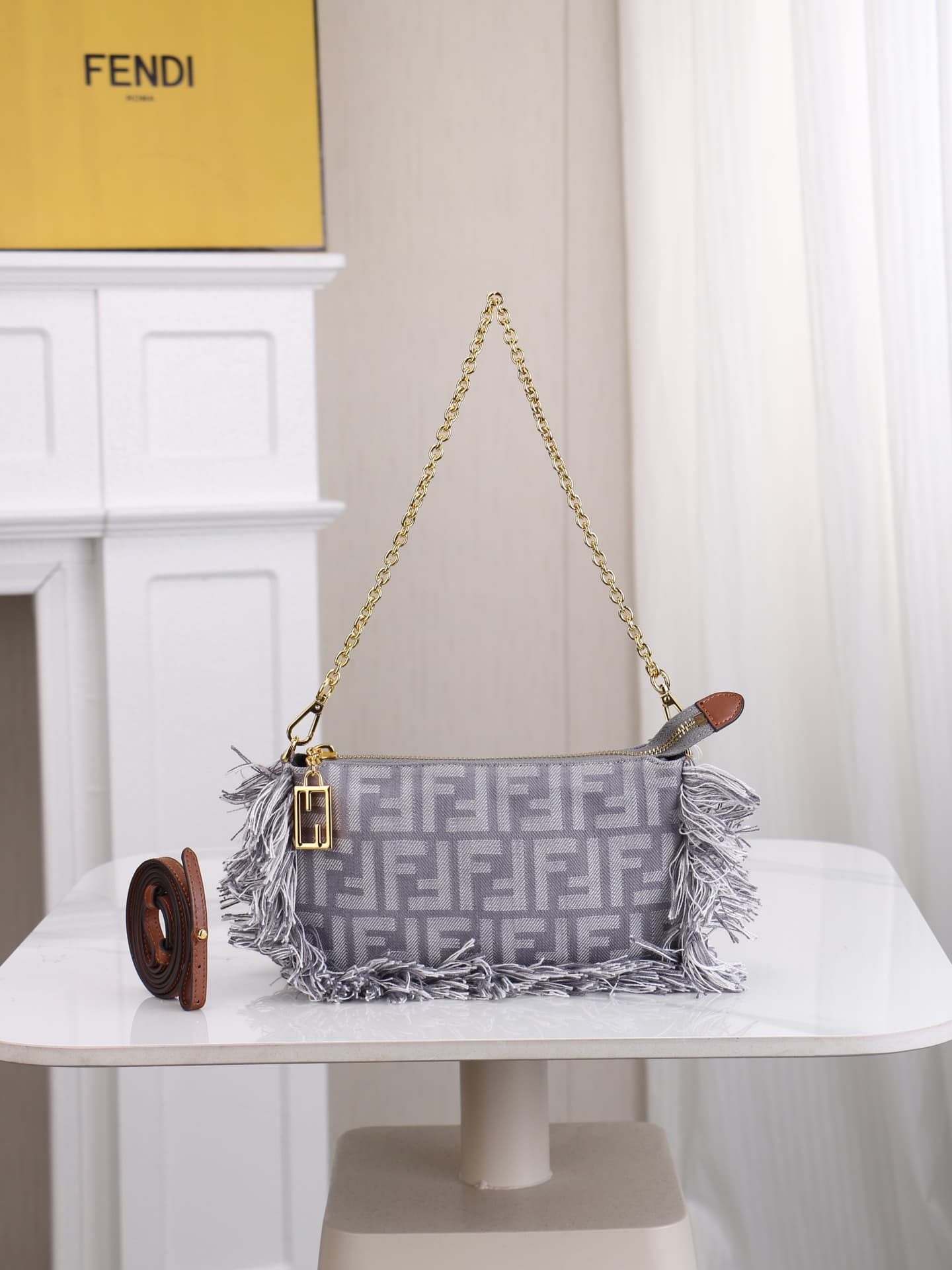 C2860 Model 7717 Baguette handbag. Made of denim print material, with classic double F logos. Features detachable thin chains and long shoulder straps. Closes with zippers, and the zipper pulls have the distinctive FF pattern. It’s compact and elegant; pe — image 1