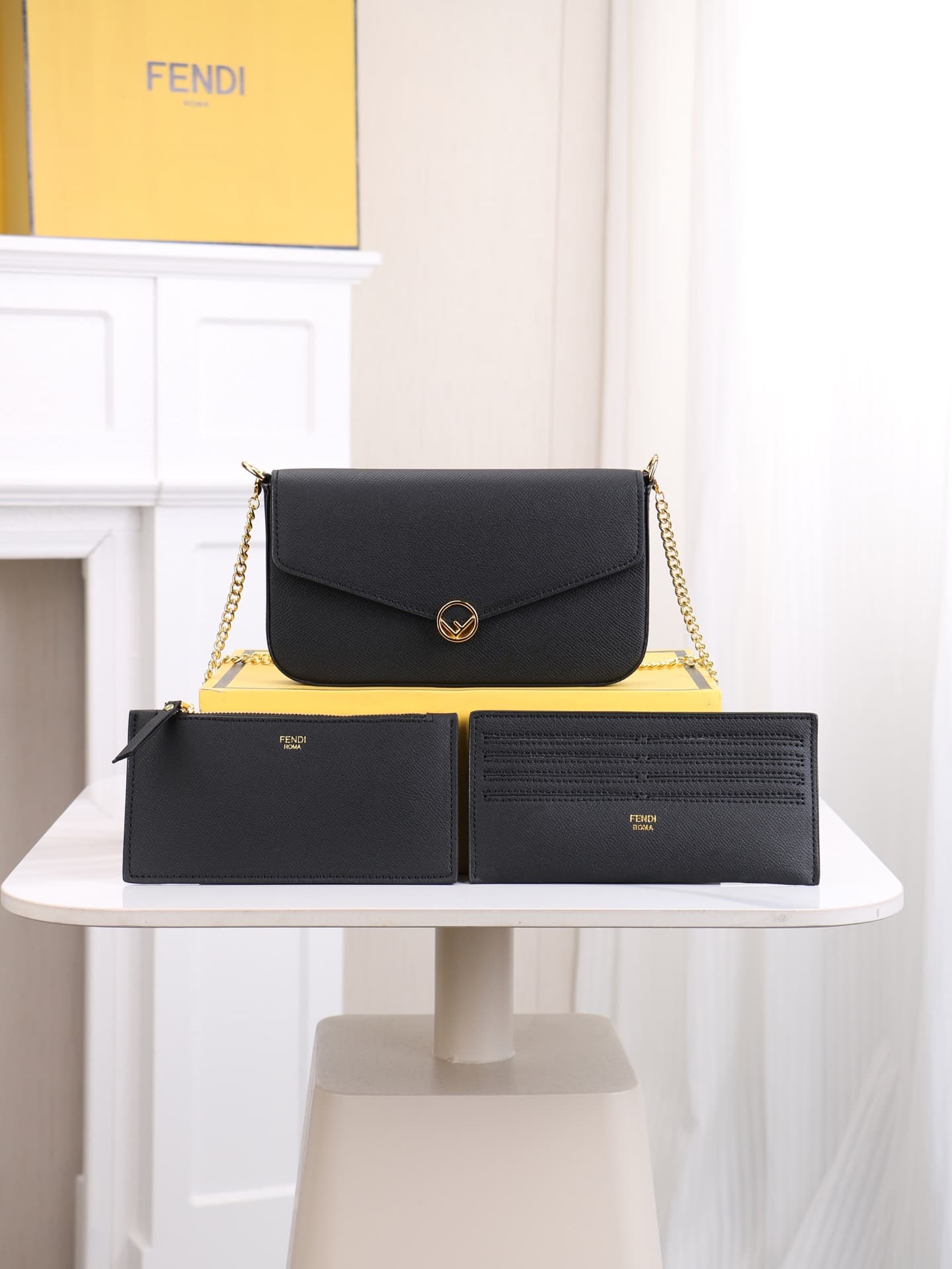 C2868 Fendi mini handbag with geometric pattern snap closures, detachable chain shoulder strap. Inner lining features flat pockets. The bag is made of iconic brown leather with black raised FF print; it comes with two detachable inner pockets – one made o — image 1
