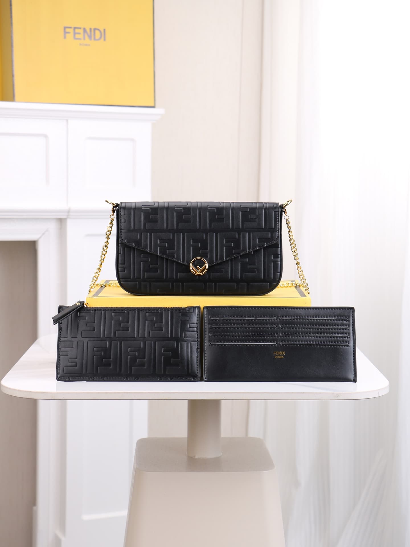 C2867 Fendi mini handbag with geometric pattern snap closure, featuring a detachable chain strap. It has a flat pocket inside. The bag is made of iconic brown leather with black raised FF patterns; it comes with two detachable inner pockets – one made of — image 1