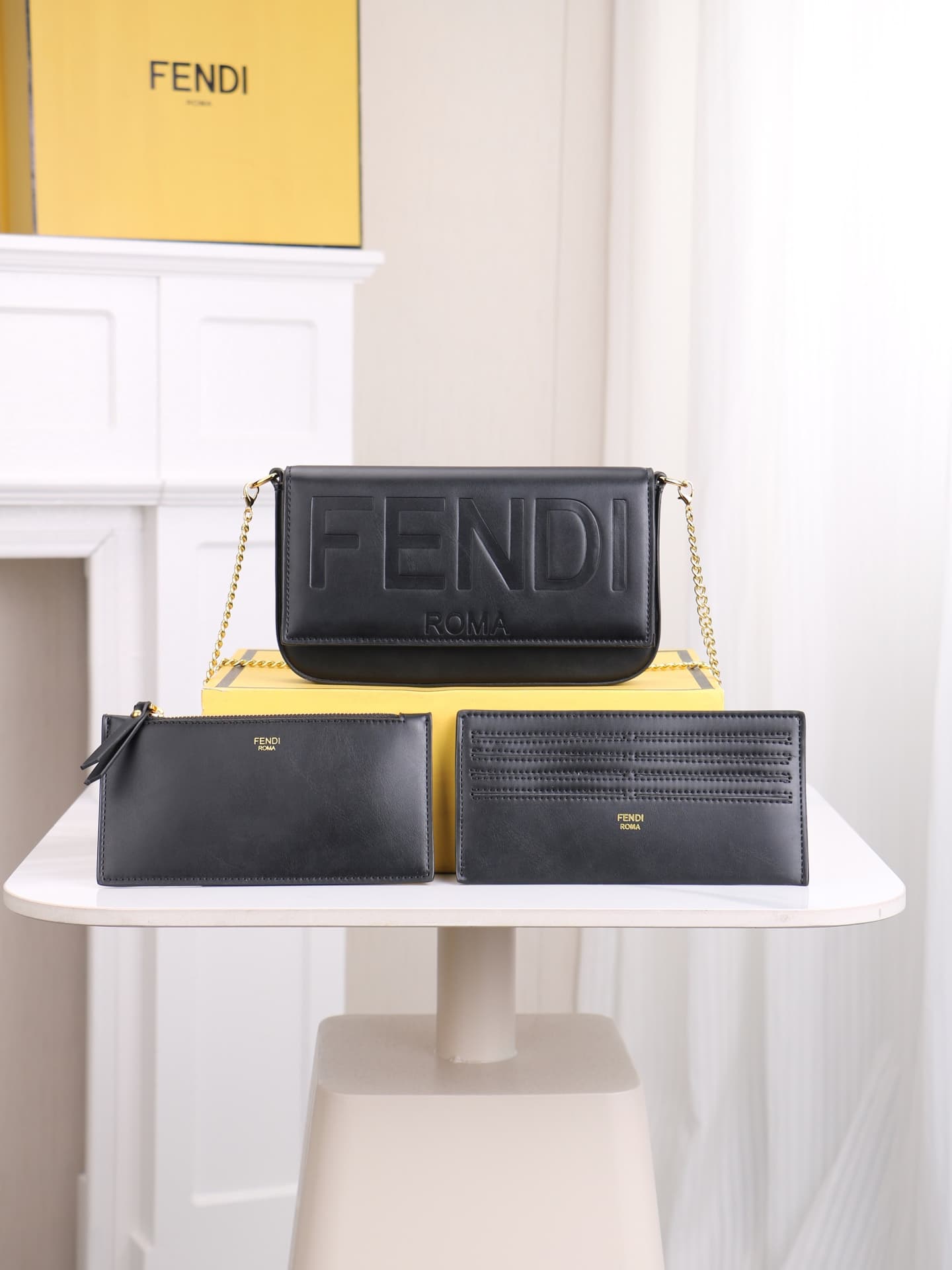 C2864 Fendi mini handbag with geometric pattern flap, equipped with zipper closure. Removable chain shoulder strap. Inner lining features flat pockets. The bag’s exterior is made of iconic brown leather with black raised FF print patterns. It includes two — image 1