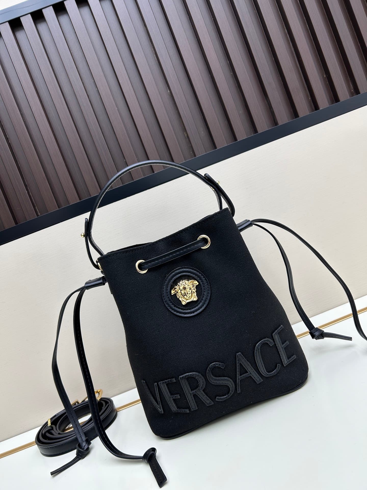 C8387 . New model 🆕 available for sale: Versace women’s straped bucket bag. High-quality material, large capacity – it really holds a lot of things. It comes with long and short shoulder straps — image 1