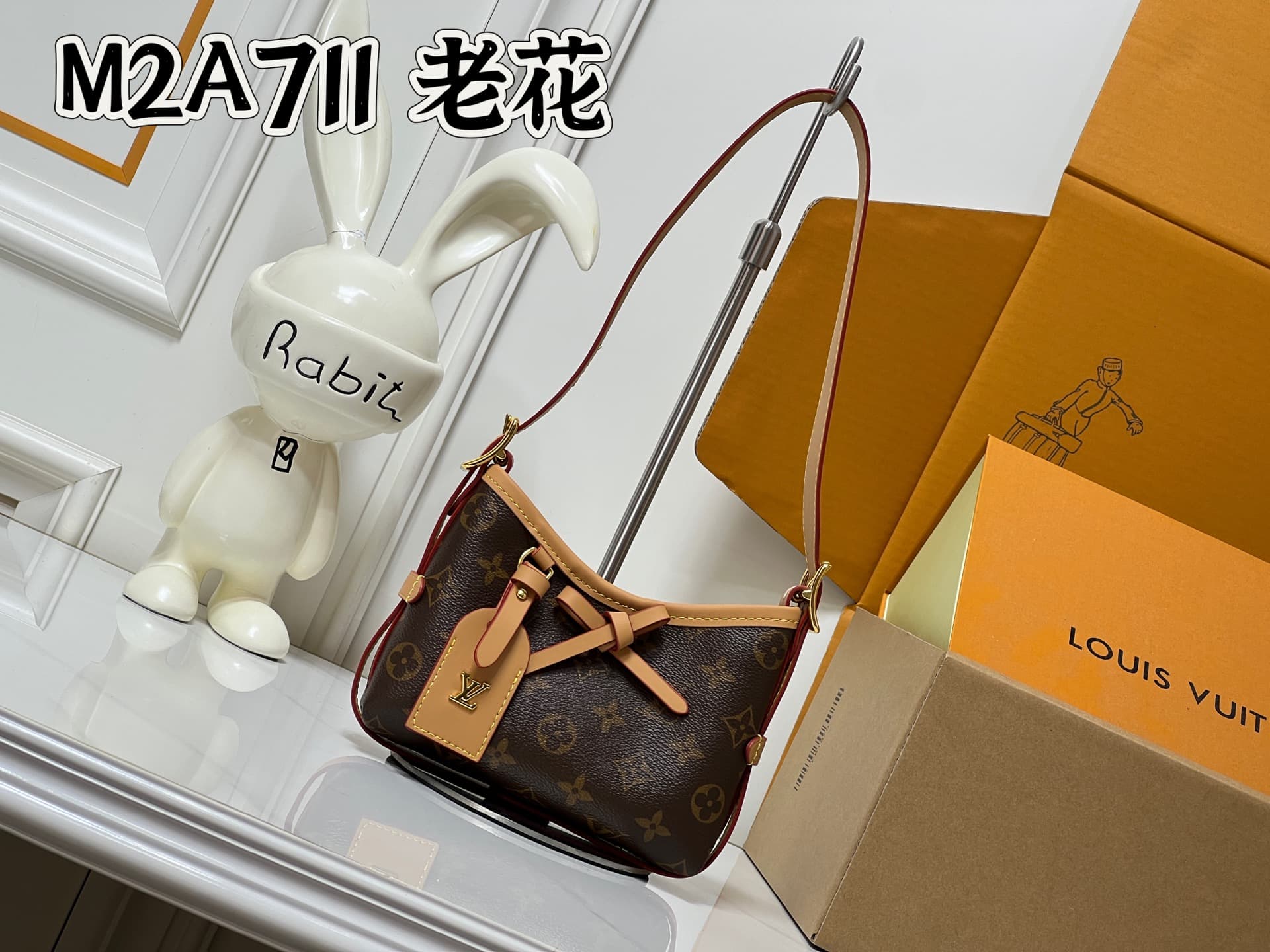 C5077 💰M2A711 Patterned design. This Nano CarryAll handbag brings a fresh touch of classic style to everyday use. The monogram pattern is presented on canvas, with contrasting leather trim at the straps; the details are elegant, and the name tag features — image 1