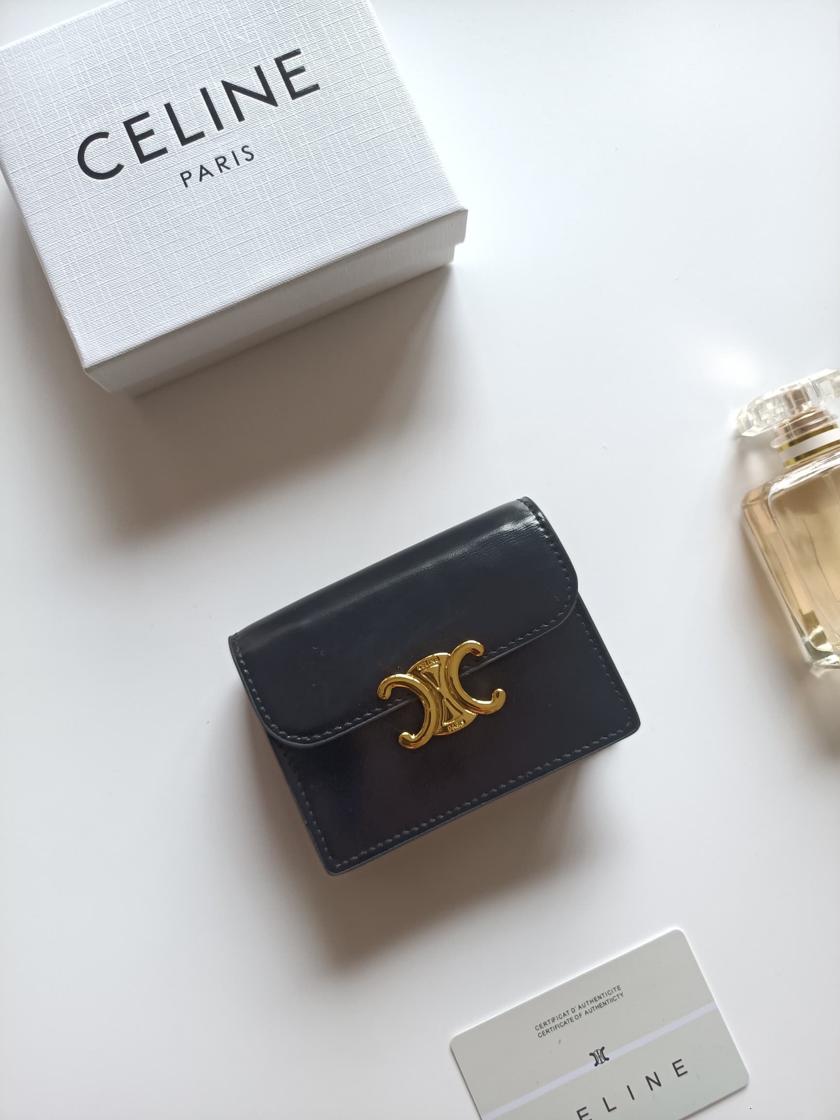 C458 Celine’s new card bag, TRIOMPHE namecard bag. It features a classic pattern on the large interior surface, with flat-texted microfiber material. The bag has a golden metallic zipper closure. It includes one thick inner compartment and one card slot o — image 1