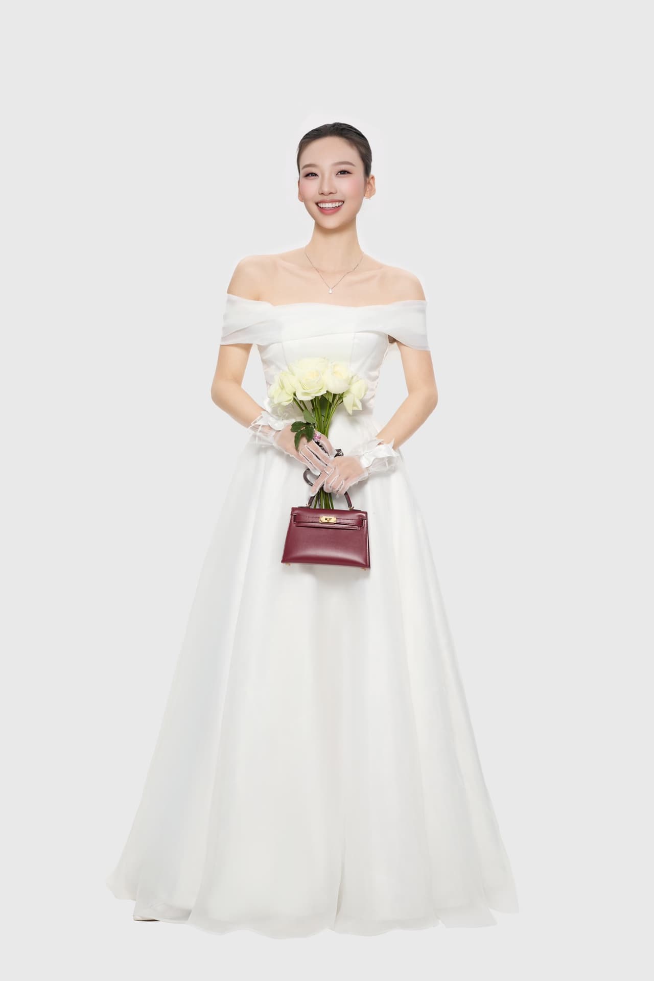 C4856 The white veil reflects purity; Kelly19 embodies Hermès’ red accents and perfection. The mini-sized design does not restrict the fluffy skirt edge; the intense red leather contrasts with the white satin. The H-button pairs well with the diamond deco — image 1
