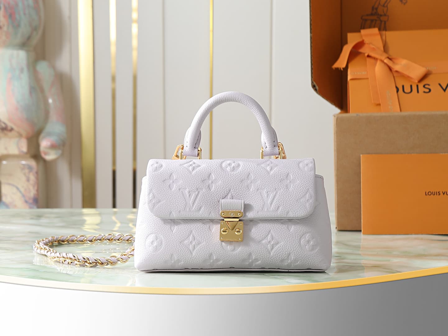 C5187 【Top-quality original items, exclusive real photos】M29380 light purple, full leather embossing, chain bag collection. New season model. NANO MADELEINE handbag. M12145 milky white. This Nano Madeleine handbag features Monogram Empreinte leather, repr — image 1