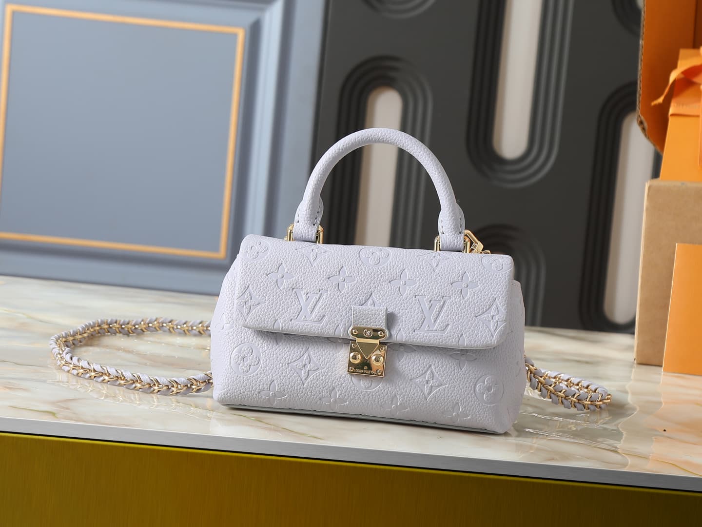 C5151 💰 Upgrade from the original M27034, M25596, M13796, M12145, M12144, and M12211. The Nano Madeleine handbag features a new season of dreamy colors, allowing easy styling in various ways. The classic Monogram Empreinte leather body is paired with the — image 1