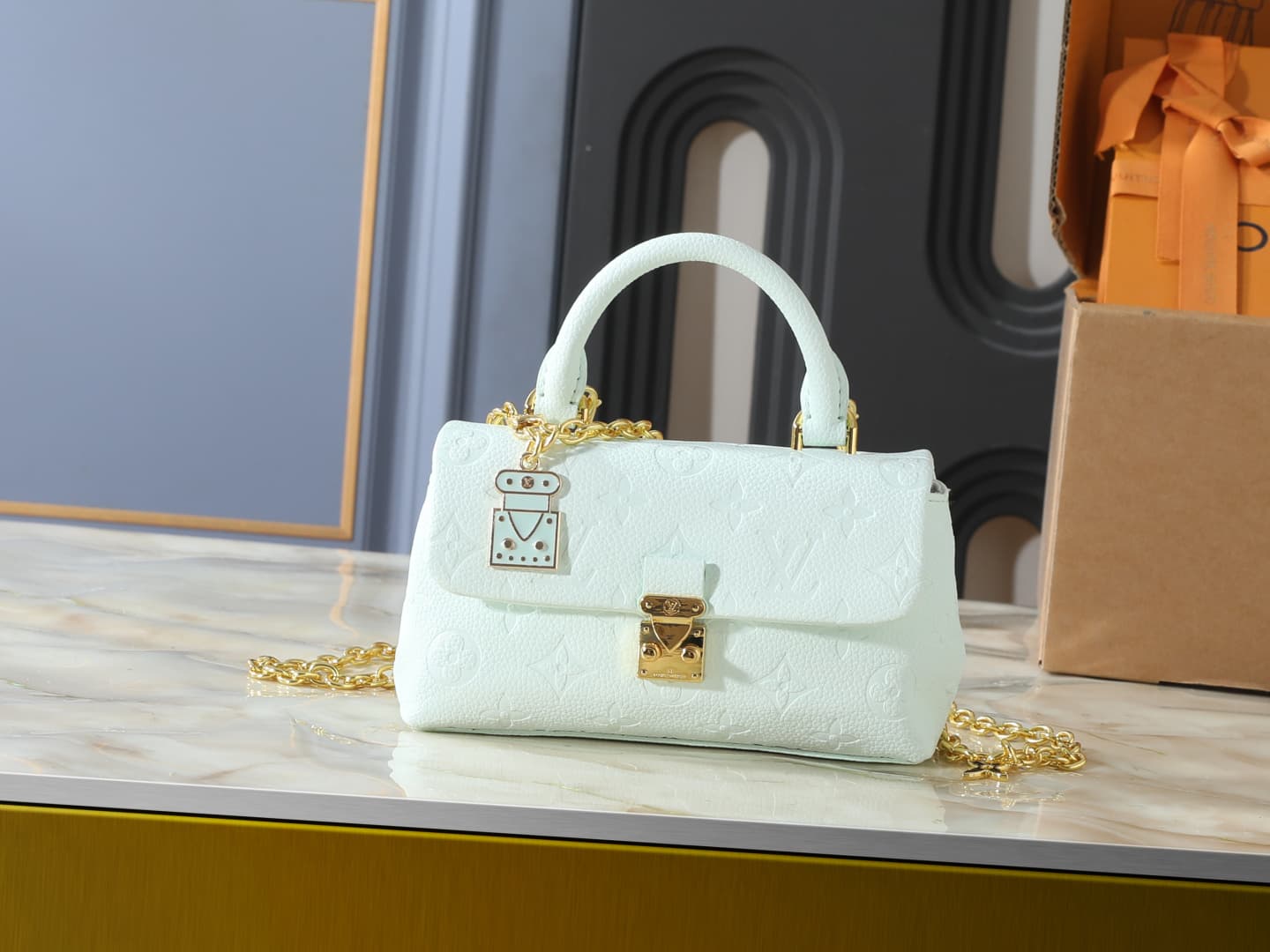 C5012 💰 Upgrade from the original M29785, M27034, M25596, M13796, M12145, M12144, and M12211. The Nano Madeleine handbag features a new seasonal design with colorful accents that can easily enhance various styles. The classic Monogram Empreinte leather bo — image 1